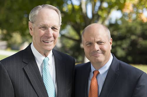 Agent next to sold sign